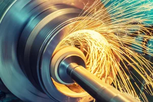 Internal grinding of a cylindrical part with an abrasive wheel on a machine, sparks fly in different directions.
