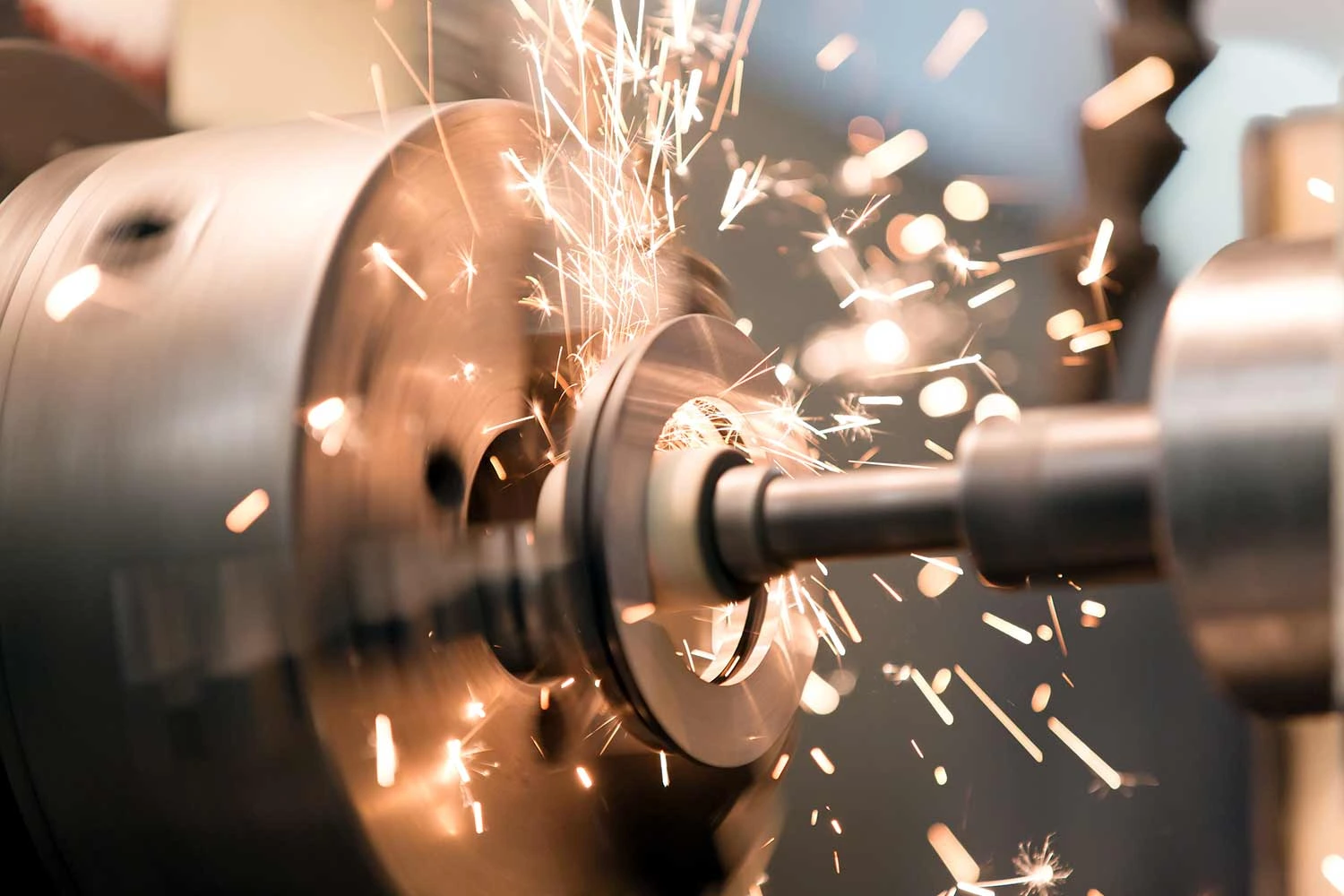 Metalworking industry: finishing metal working internal steel surface on lathe grinder machine with flying sparks